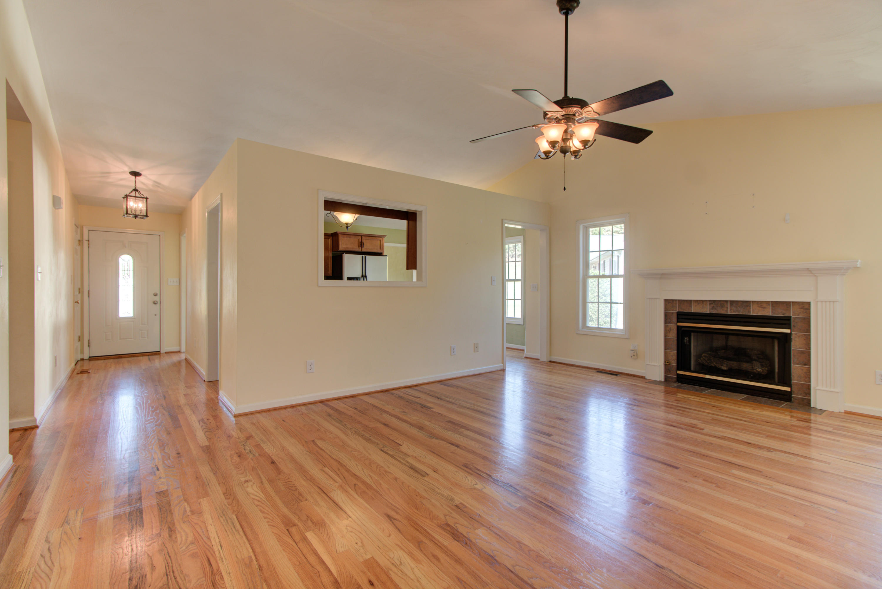 1781 Meadows Road Vinton, VA 24179 - Photo 13 of 26 a view of a livingroom with wooden floor a ceiling fan and windows