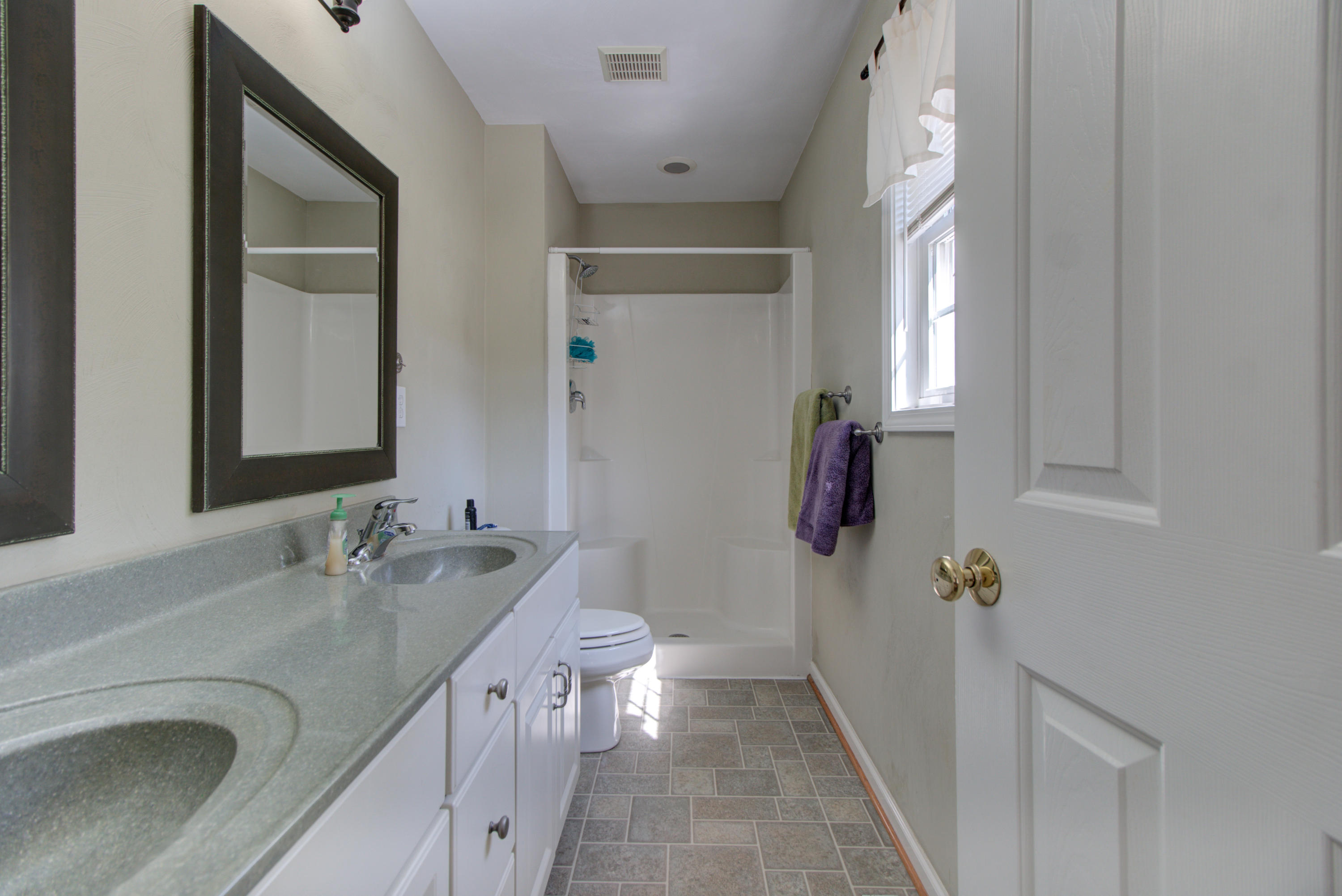 1781 Meadows Road Vinton, VA 24179 - Photo 19 of 26 a bathroom with a granite countertop sink a toilet and shower