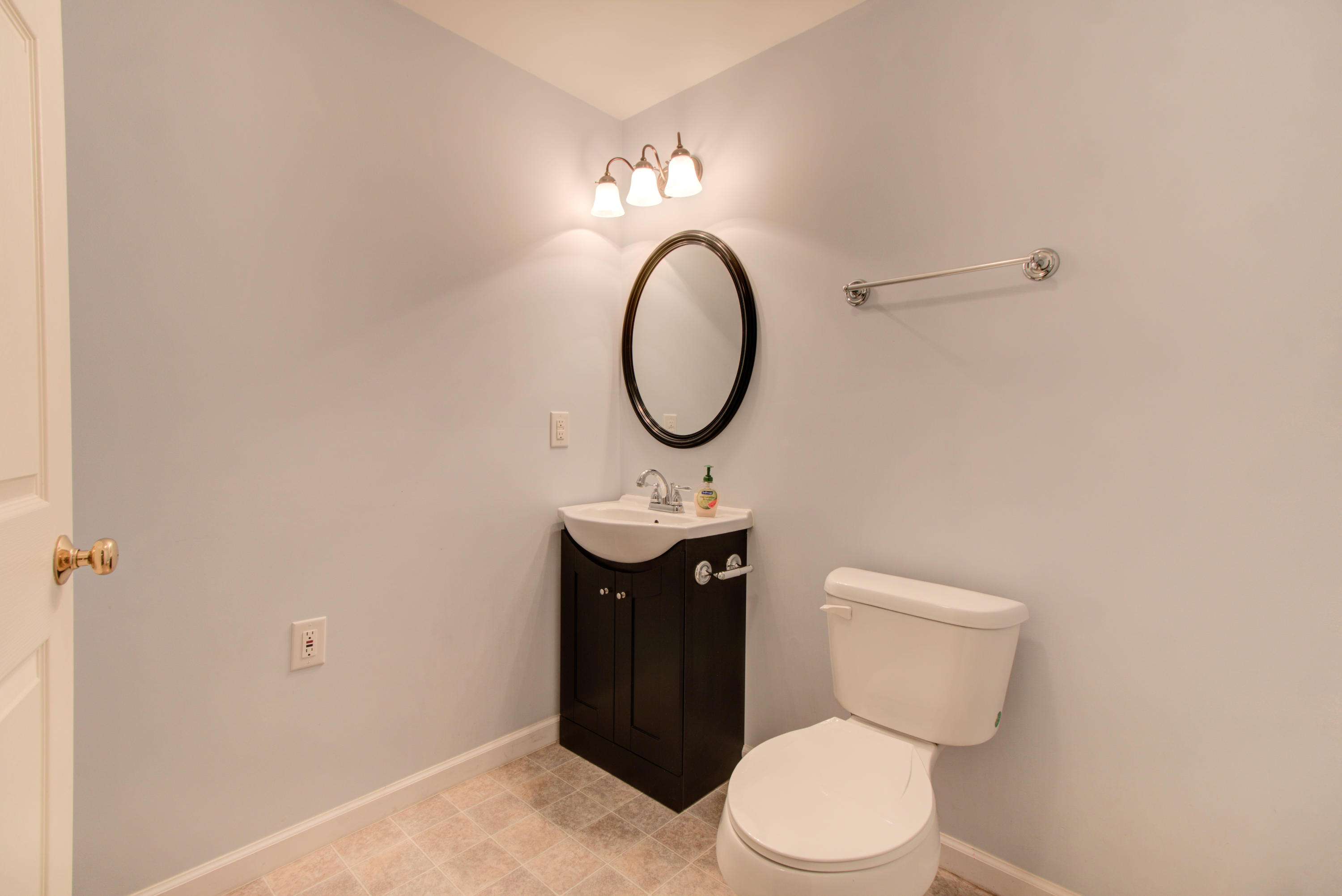 1781 Meadows Road Vinton, VA 24179 - Photo 21 of 26 a bathroom with a toilet a sink and a mirror