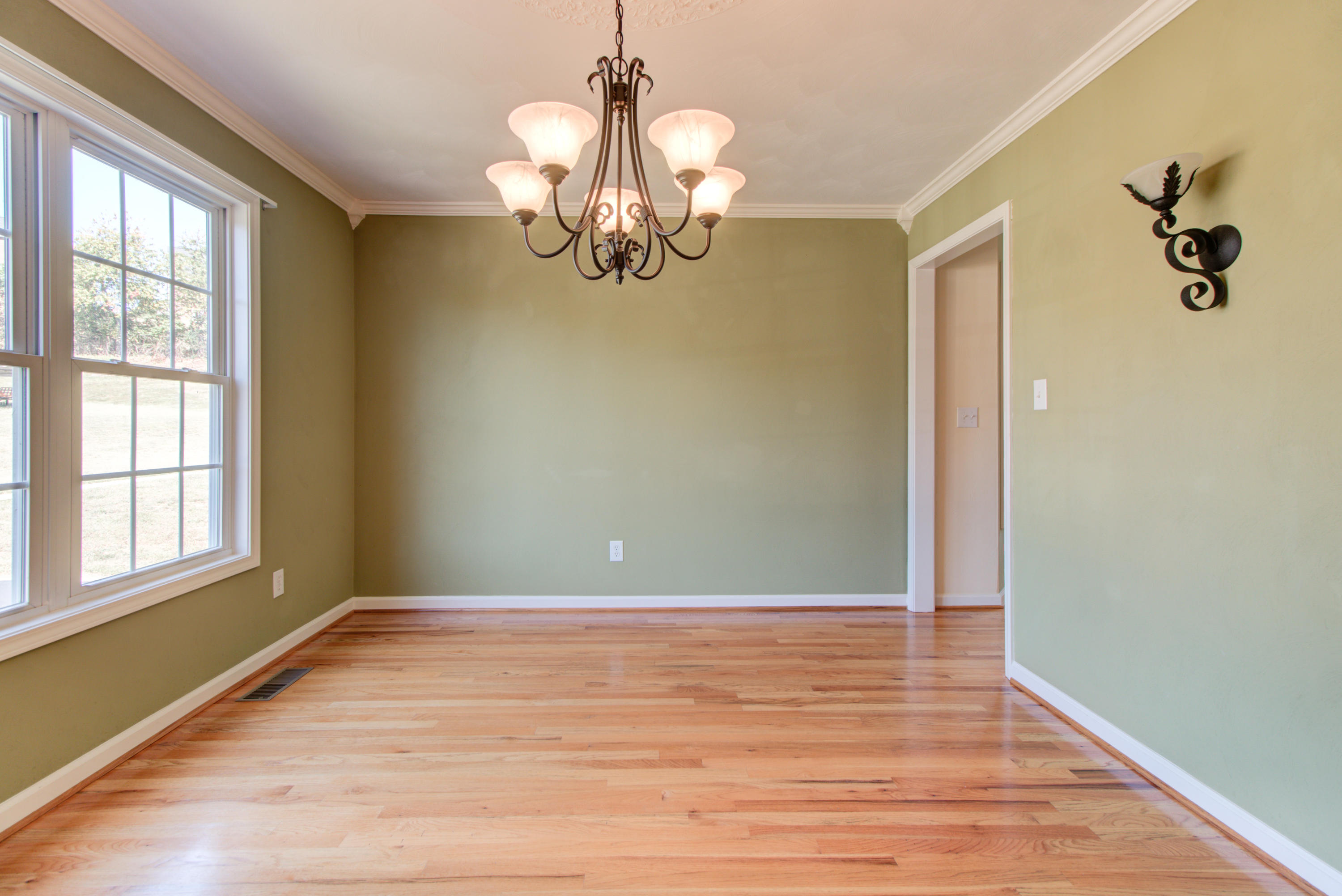 1781 Meadows Road Vinton, VA 24179 - Photo 6 of 26 an empty room with wooden floor fan and windows