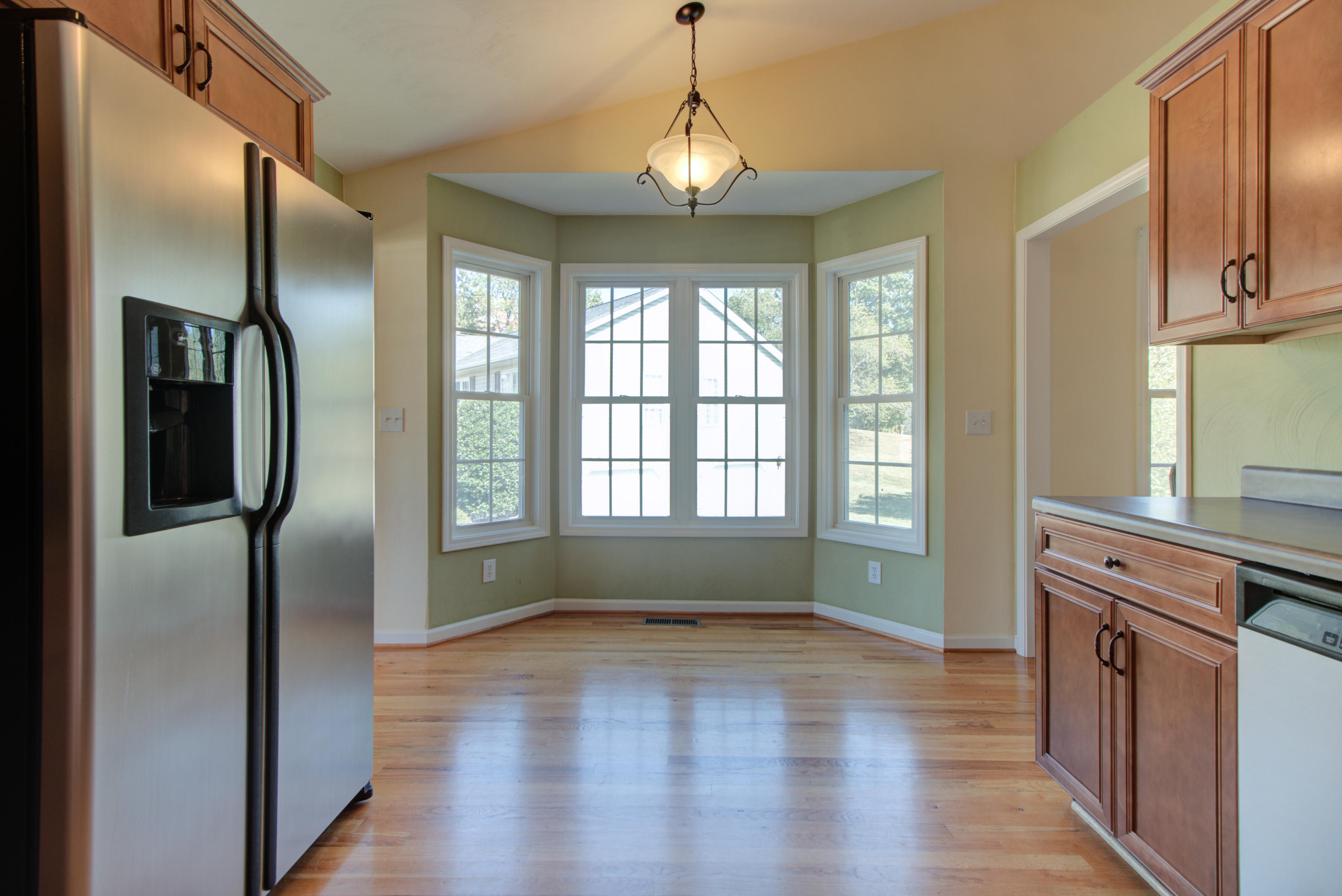 1781 Meadows Road Vinton, VA 24179 - Photo 8 of 26 a kitchen with stainless steel appliances granite countertop a refrigerator a stove and a wooden floors