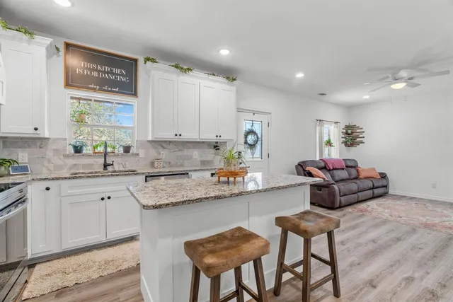 a kitchen with a sink cabinets and window