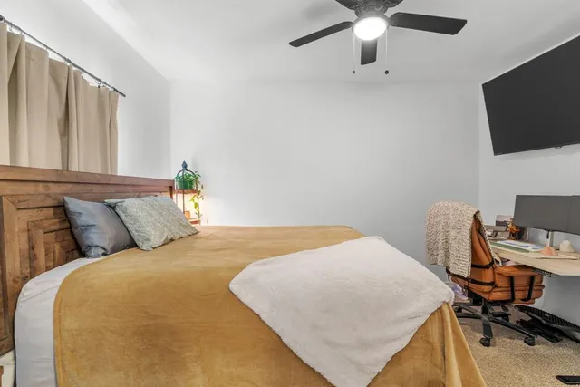 a bedroom with a bed and a flat screen tv