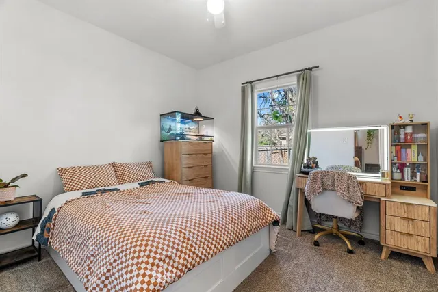 a bedroom with a bed and a desk