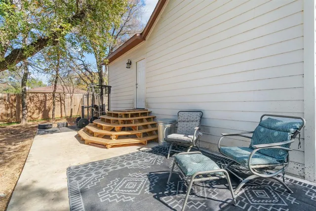 a backyard of a house with table and chairs