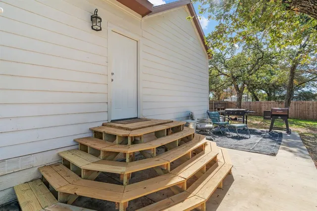 a view of a patio with a table and chairs