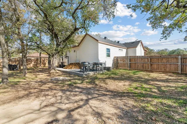 a view of a yard with a large tree