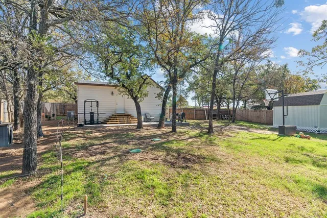 a backyard of house with trees