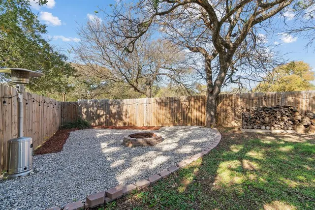 a view of a yard with plants and trees