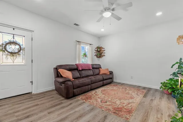 a living room with furniture and a potted plant