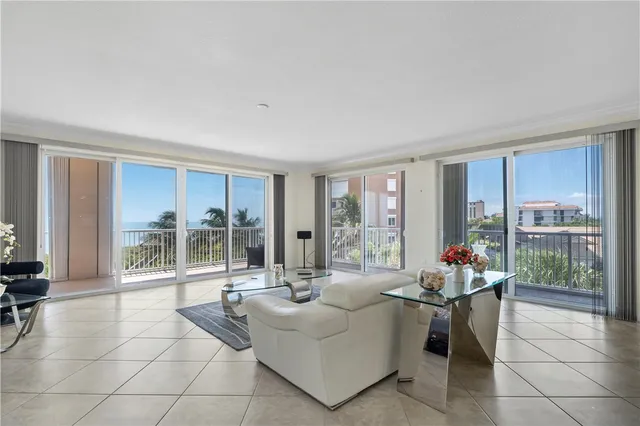 a living room with furniture and large windows