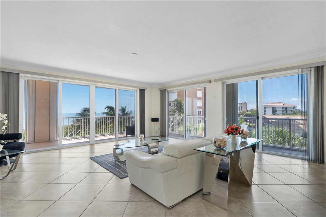 a living room with furniture and large windows