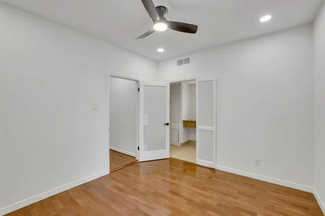 a view of empty room with wooden floor