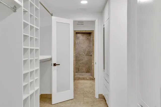 a view of a bedroom with wooden floor and closet