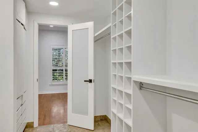 a view of walk in closet with empty racks