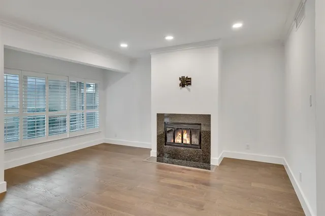 a view of an empty room with a fireplace