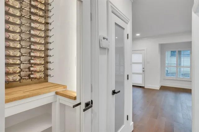 wooden floor in an empty room with a bathroom