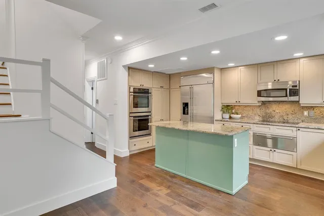 a kitchen with counter top space cabinets and stainless steel appliances