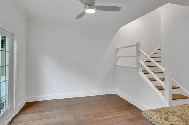 an empty room with windows and stairs
