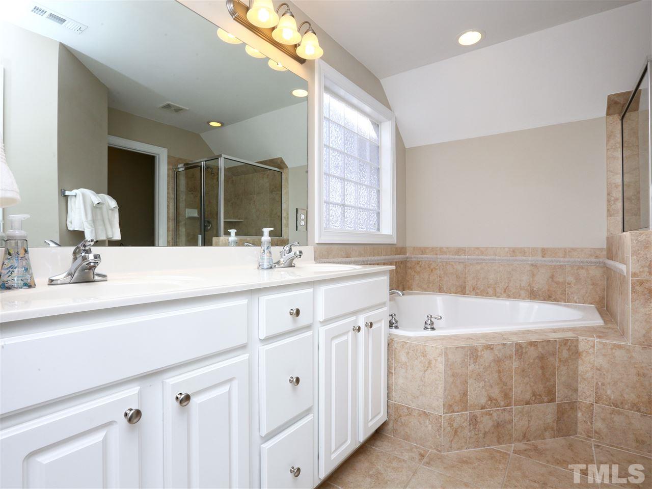 2220 Karns Place Raleigh, NC 27614 - Photo 12 of 25 a bathroom with a tub a sink and mirror