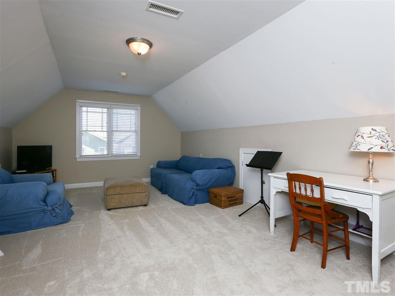 2220 Karns Place Raleigh, NC 27614 - Photo 17 of 25 a living room with furniture a flat screen tv and a window