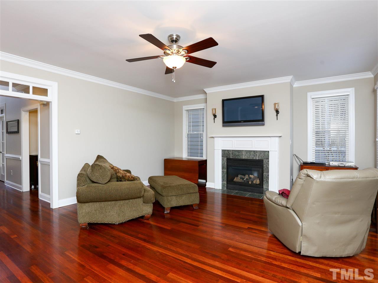 2220 Karns Place Raleigh, NC 27614 - Photo 8 of 25 a living room with furniture a flat screen tv and a fireplace
