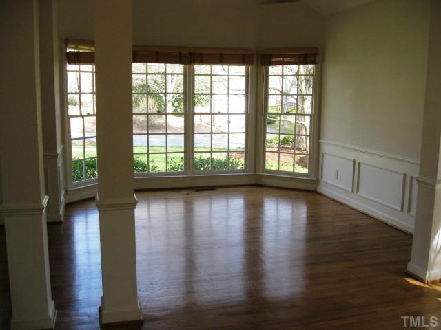 704 Manor Ridge Road Carrboro, NC 27510 - Photo 3 of 21 wooden floor in an empty room with a window