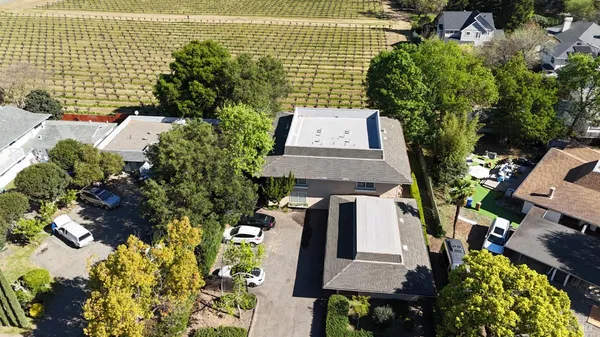 an aerial view of a house with a yard and garden
