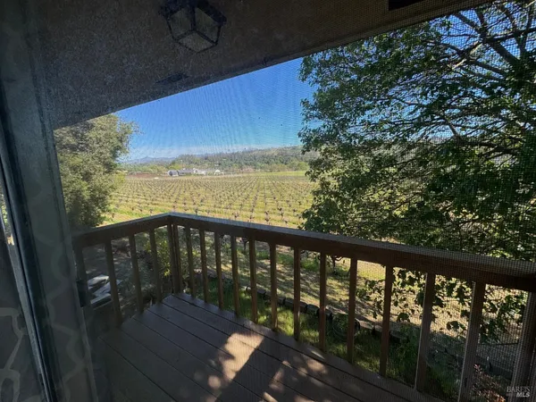 a view of roof deck with wooden floor and fence