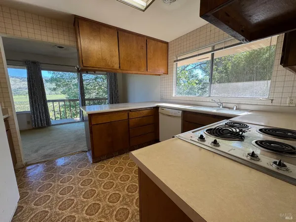 a kitchen with a stove a sink and a cabinets