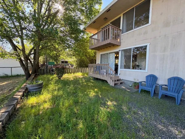 a view of a house with backyard and sitting area