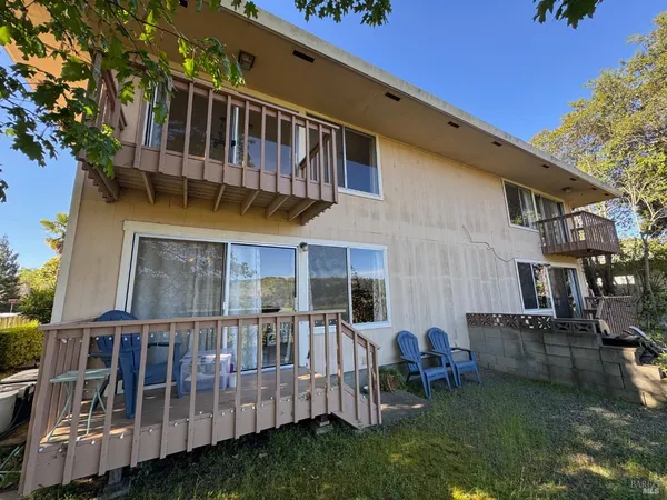 a view of a house with backyard and sitting area