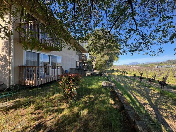 a view of a yard with wooden fence