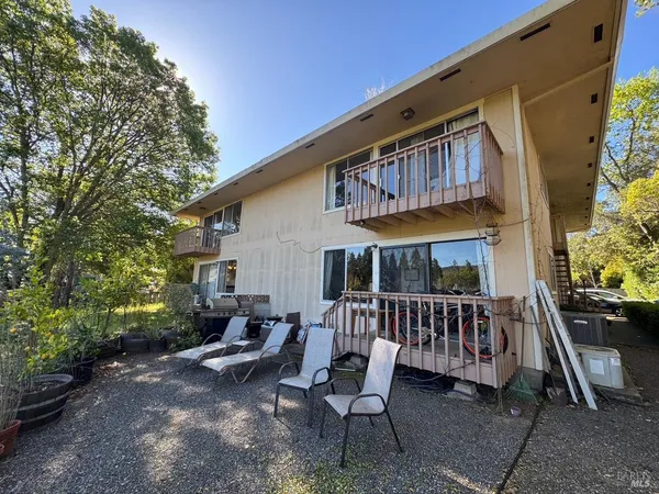 a view of a patio with a table and chairs