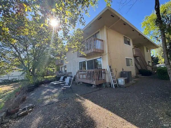 a view of a house with a yard and sitting area