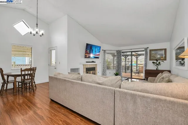 a kitchen with stainless steel appliances a stove a microwave and a hard wood floors