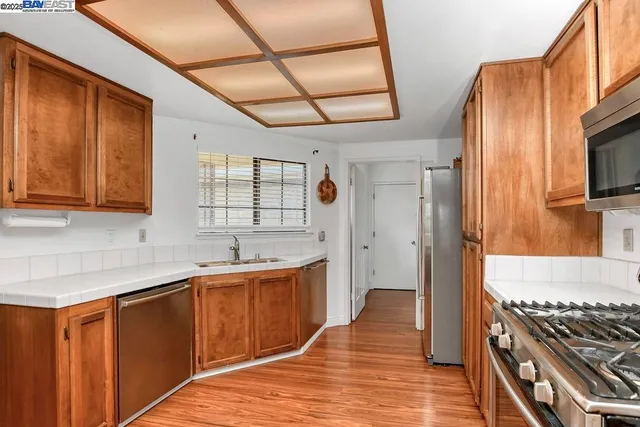 a living room with a wooden floor and a dining table with wooden floor
