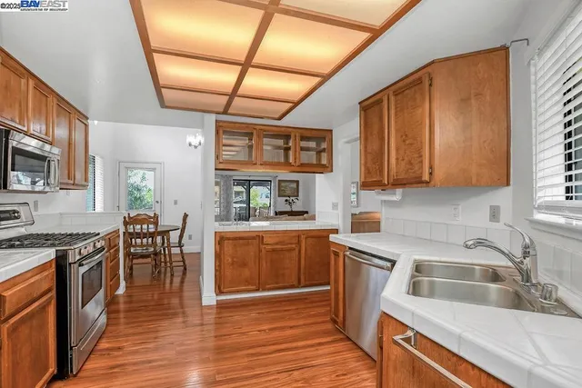a spacious bedroom with a bed and wooden floor