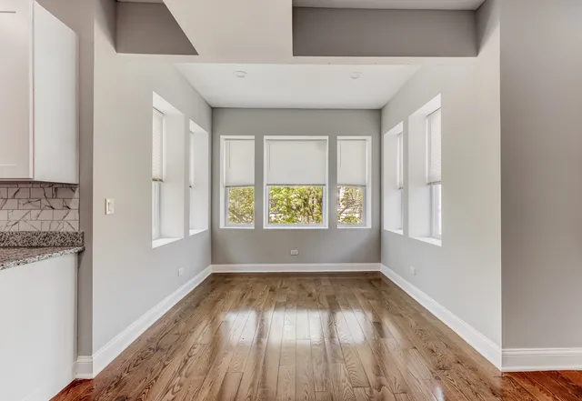 a view of wooden floor and window in a room