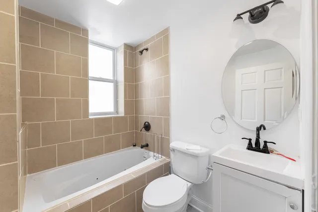 a bathroom with a toilet a sink and bathtub