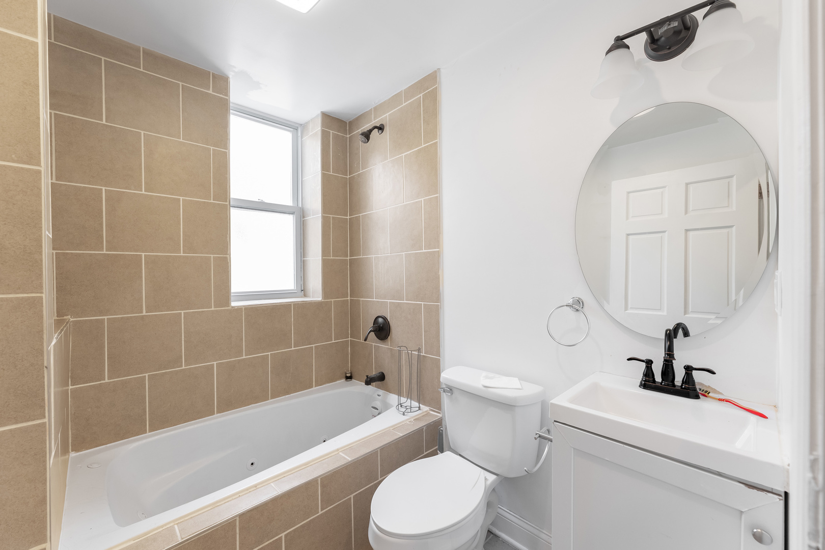 1321 South Millard Avenue, Unit C Chicago, IL 60623 - Photo 8 of 13 a bathroom with a toilet a sink and bathtub