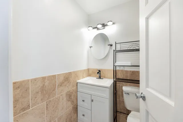 a bathroom with a sink vanity and toilet