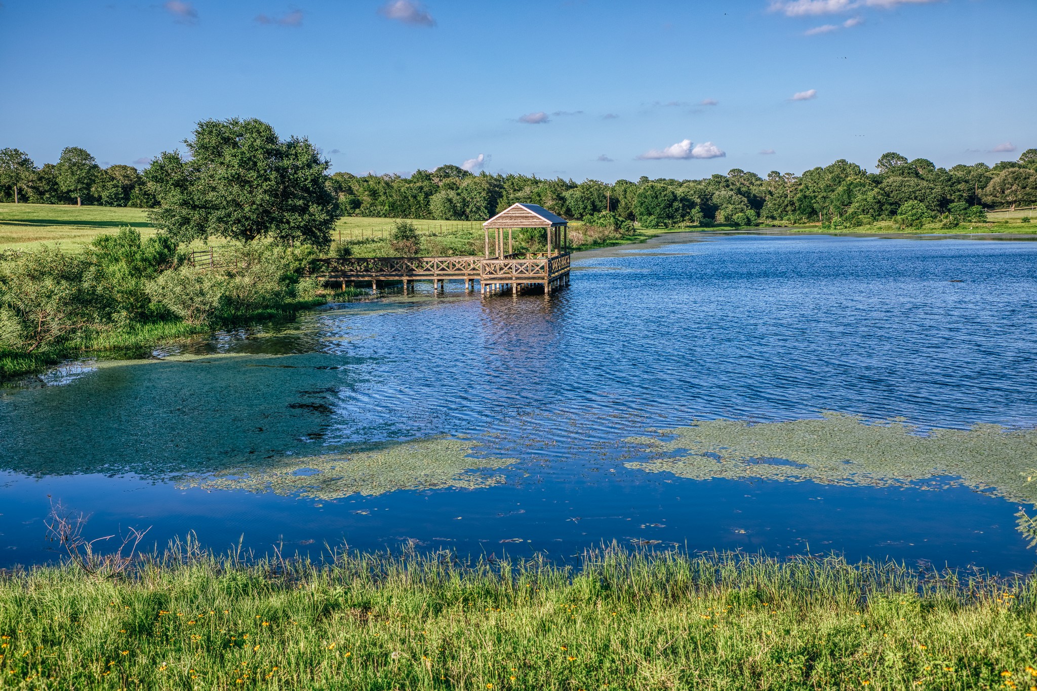 1034 Hilbun Road New Ulm, TX 78950 - Photo 39 of 49 Take in sweeping lake views from the covered dock, where electricity, fishing opportunities, and the beauty of a stocked 7-acre lake come together in a truly remarkable setting.