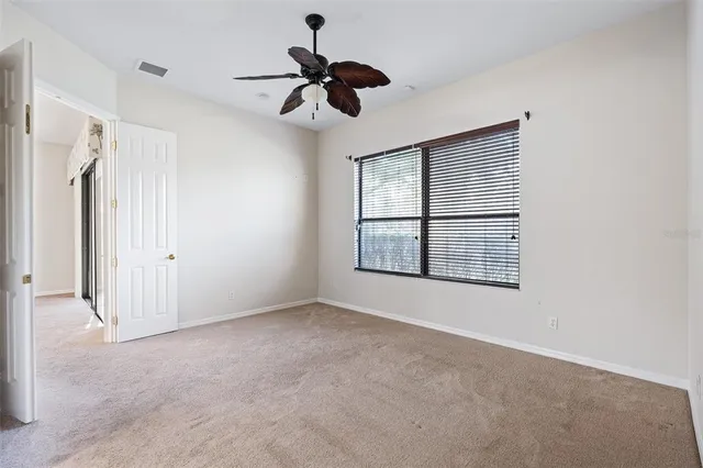 a bedroom with a large bed and a potted plant