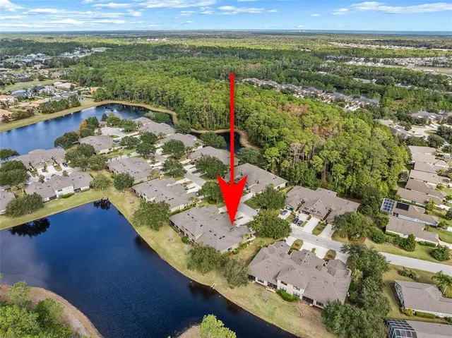 an aerial view of residential houses with outdoor space and swimming pool