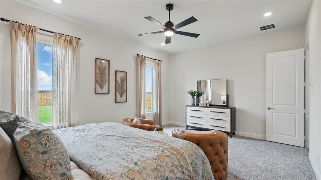 1016 Pitchfork Road Royse City, TX 75189 - Photo 19 of 35 a bedroom with a large bed and a chandelier