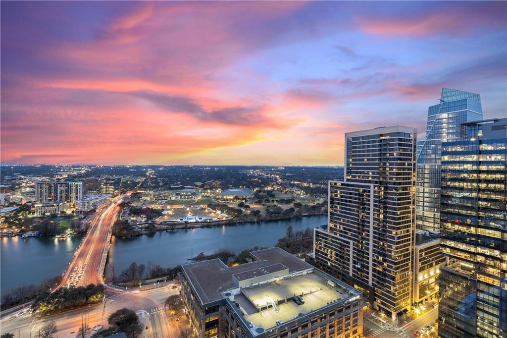 210 Lavaca Street, Unit 2706 Austin, TX 78701 - Photo 30 of 32 Expansive urban landscape featuring a prominent river, modern high-rise architecture, and an illuminated bridge