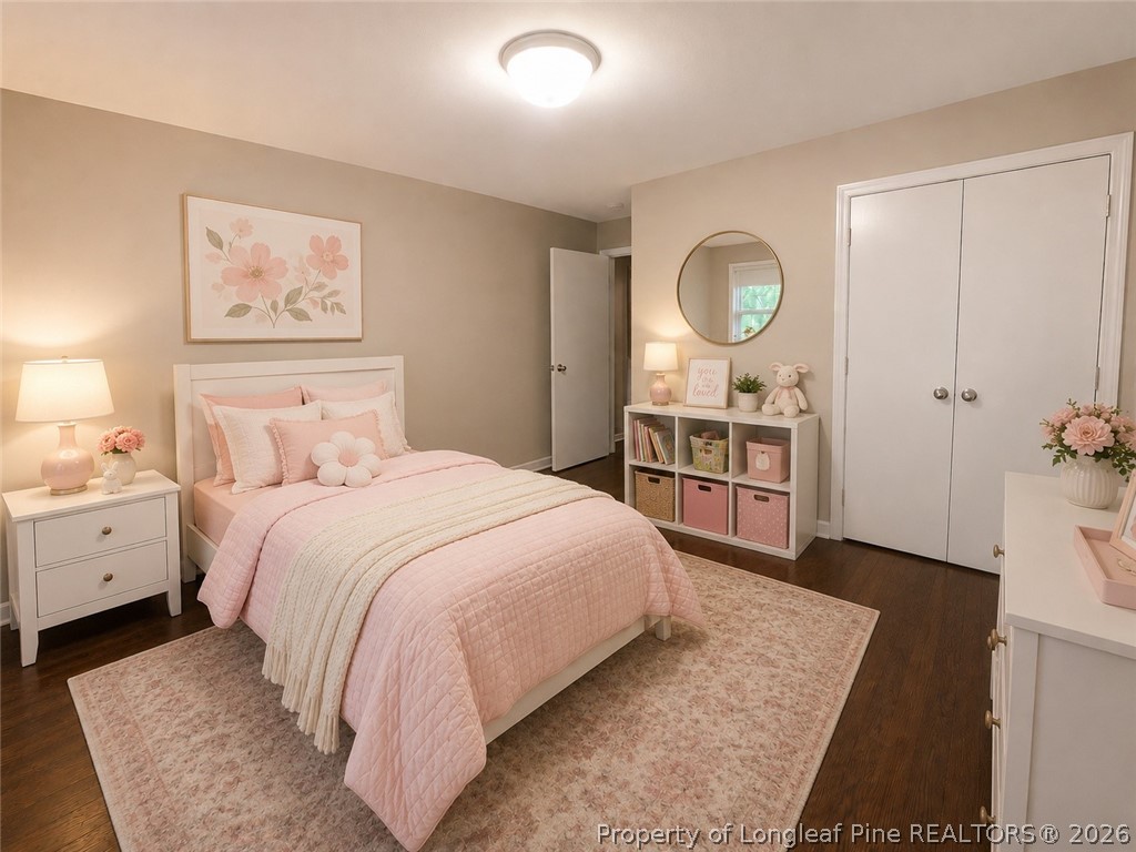 1404 Hibiscus Road Fayetteville, NC 28311 - Photo 4 of 10 a bedroom with a bed and a chandelier