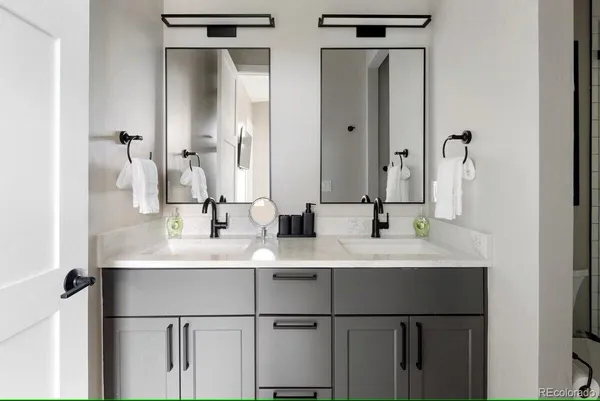 a bathroom with a double vanity sink mirror and