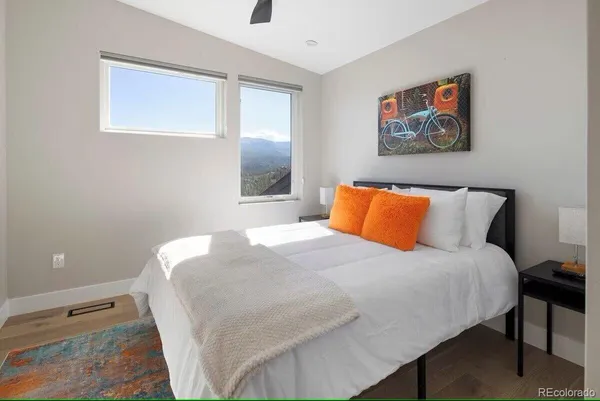 a bedroom with a bed and a painting on the wall